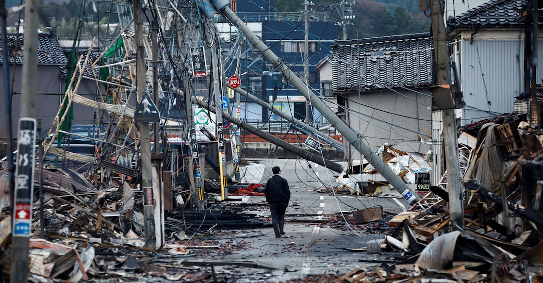 A man makes his way along Asaichi-dori street, which burned down due to a fire following an earthquake, in Wajima, Japan. Photo: Reuters