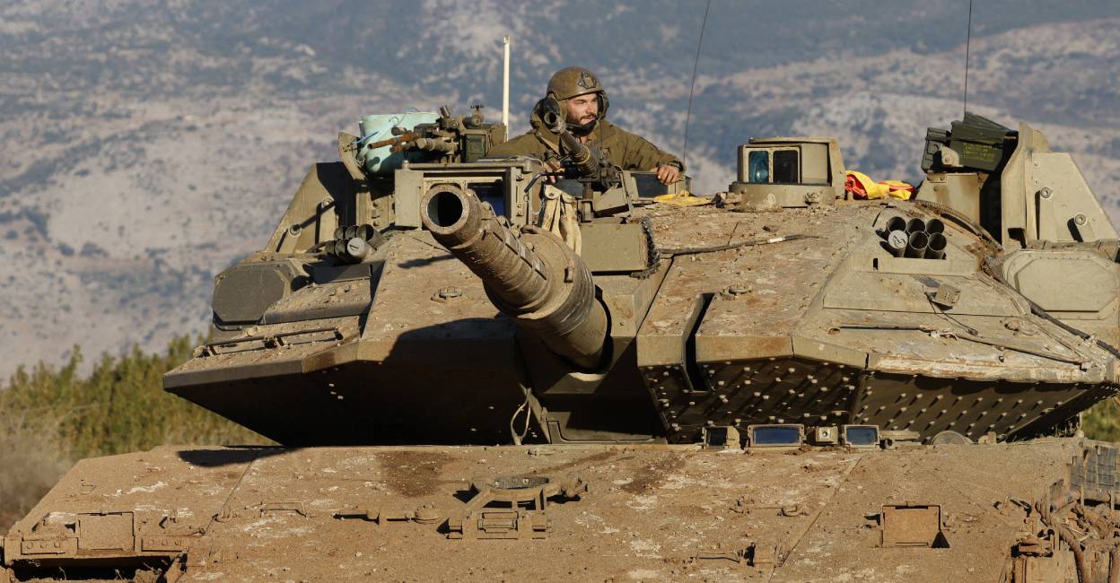 israel-army-man An Israeli soldier sits in a tank stationed near the border with Lebanon in the upper Galilee area in northern Israel. Photo: AFP