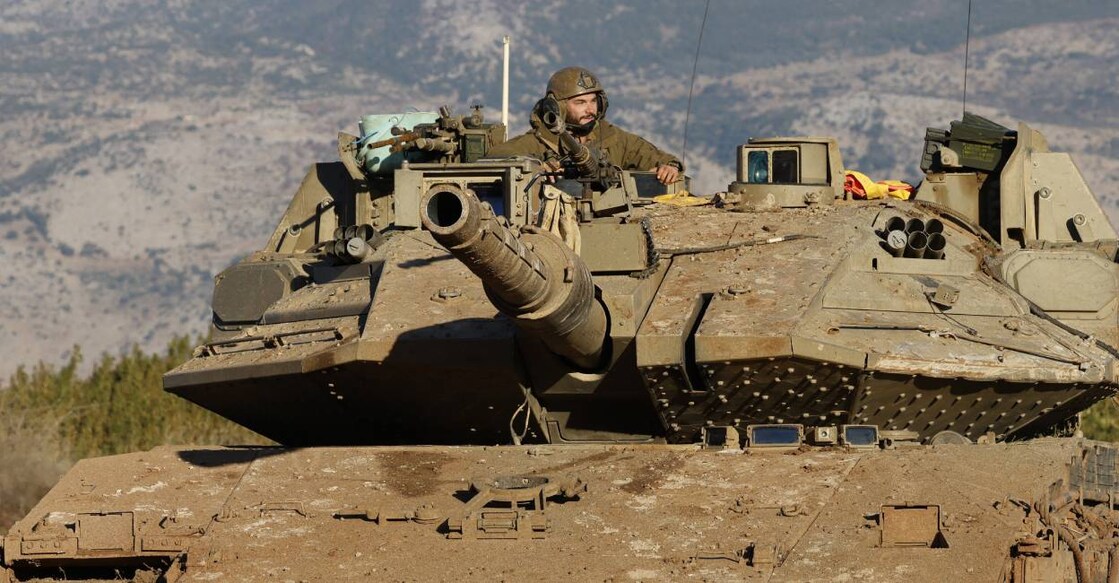 An Israeli soldier sits in a tank stationed near the border with Lebanon in the upper Galilee area in northern Israel. Photo: AFP