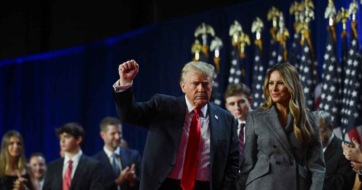 FILE PHOTO: Republican presidential nominee and former U.S. President Donald Trump holds up a fist as he takes the stage with his wife Melania and son Barron, following early results from the 2024 U.S. presidential election in Palm Beach County Convention Center, in West Palm Beach, Florida, U.S., November 6, 2024. REUTERS/Callaghan O'Hare/File Photo