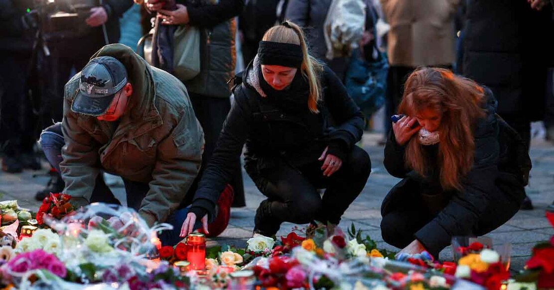 People lay candles and tributes at the site where a car drove into a crowd at a Magdeburg Christmas market in Magdeburg, Germany December 21, 2024. REUTERS/Christian Mang
