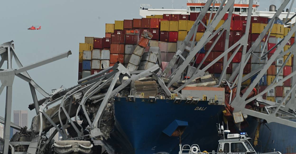 The steel frame of the Francis Scott Key Bridge sits on top of the container ship Dali after the bridge collapsed, Baltimore, Maryland, on March 26, 2024. Photo: AFP