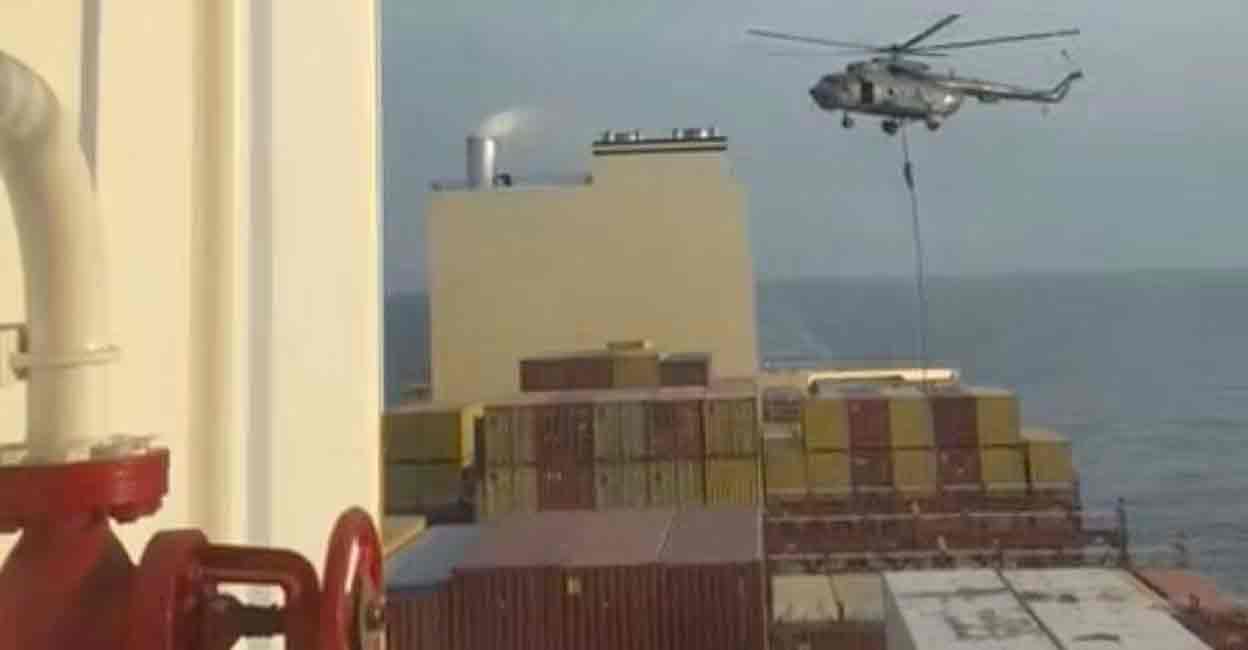 An official slides down a rope during a helicopter raid on MSC Aries ship at sea in this screen grab obtained from a social media video released on April 13, 2024. Video obtained by Reuters