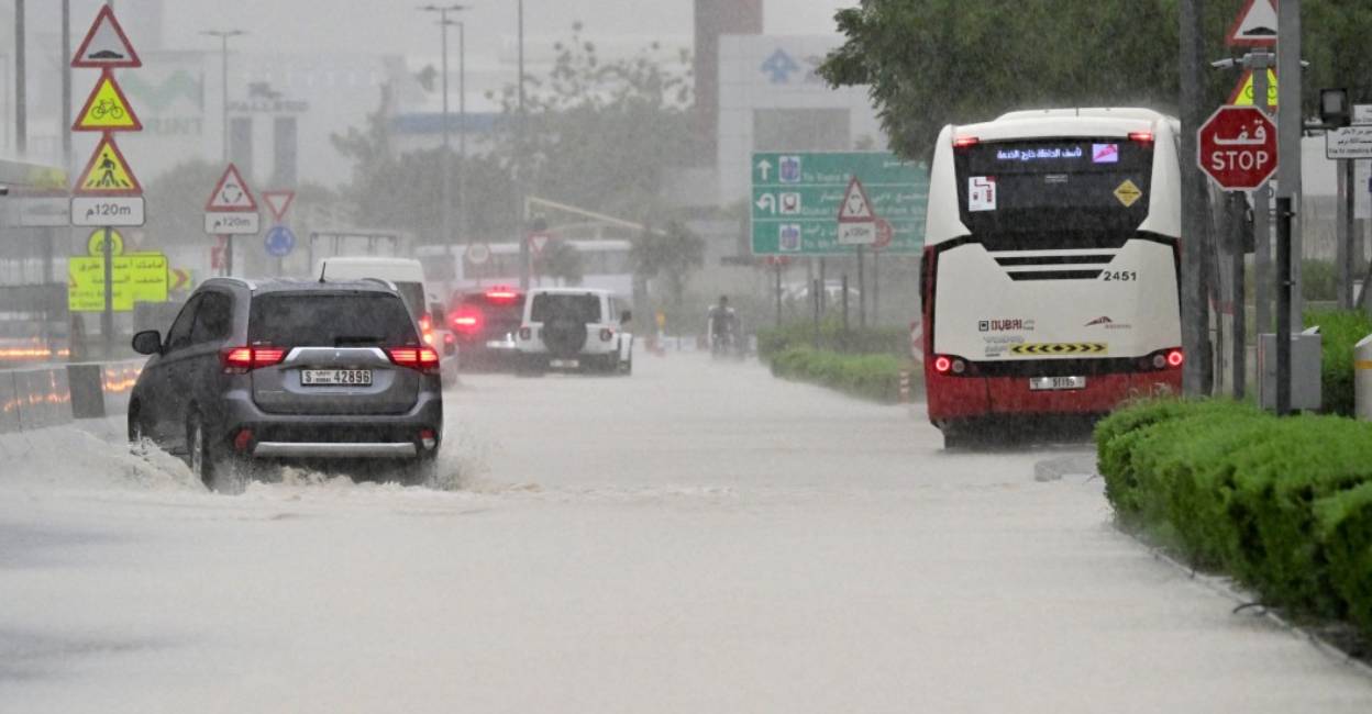 flooded-in-dubai Vehicles drive on a flooded road during torrential rain in the Gulf Emirate of Dubai. Photo: AFP