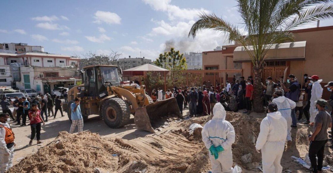 Palestinian health workers dig for bodies buried in Nasser hospital compound in Khan Yunis in the southern Gaza Strip . Photo: AFP