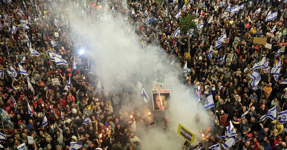 israel-protest Protesters hold placards and wave Israeli flags during a demonstration in front of the Defence Ministry in the Israeli coastal city of Tel Aviv. Photo: AFP