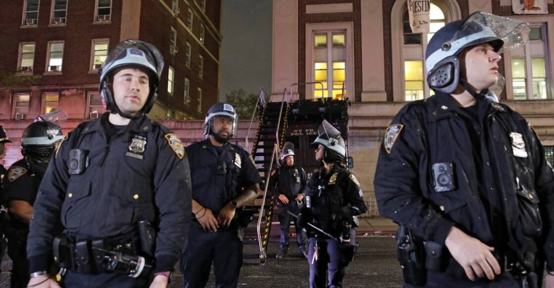 NYPD officers stand guard in riot gear as they evict a building that had been barricaded by pro-Palestinian student protesters at Columbia University.  Photo: AFP