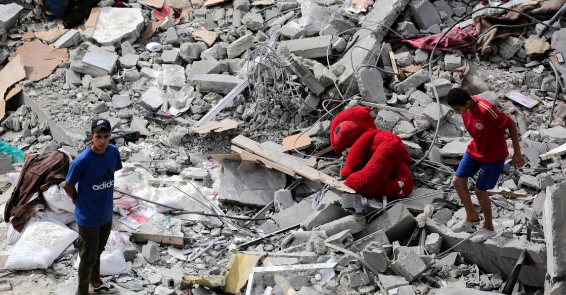 Palestinians check the rubble of a residential building destroyed by an Israeli strike in Al-Zawayda in the central Gaza Strip on May 11 . Photo: AFP