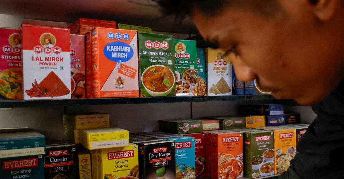 FILE PHOTO: FILE PHOTO: A man stands near the spice boxes of MDH and Everest kept on the shelf of a shop at a market in New Delhi, India, April 29, 2024. REUTERS/Adnan Abidi/File Photo