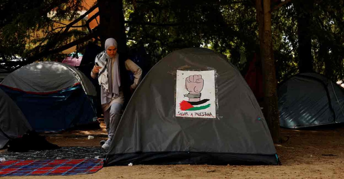 ISRAEL-PALESTINIANS/SPAIN
A student walks out of a tent with a banner that reads "Save Palestine" at a pro-Palestinian encampment by students of the Complutense University of Madrid amid the ongoing conflict between Israel and the Palestinian Islamist group Hamas, in Madrid, Spain, May 22, 2024. Spanish Prime Minister Pedro Sanchez said on Wednesday that the country's council of ministers would recognise an independent Palestinian state on Tuesday May 28. Photo: REUTERS/Susana Vera