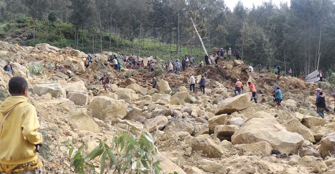 Landslide in Papua New Guinea Relief workers and people walk at a site damaged in the aftermath of landslide. New Porgera Limited/Reuters.