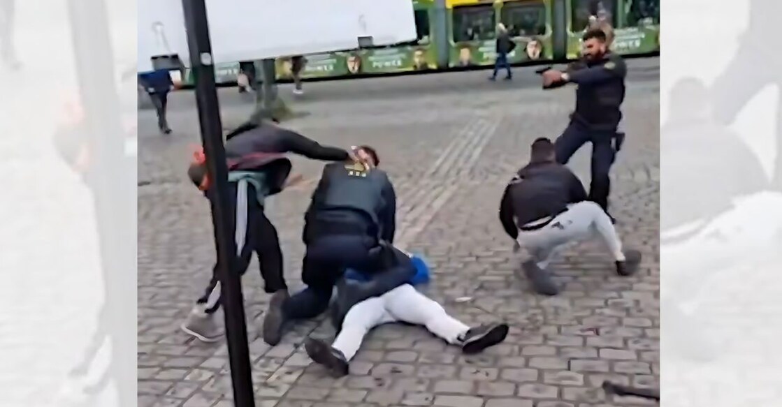 A screengrab from a video of the incident shared widely on social media shows a police officer shooting an assailant (left), who is stabbing a cop.