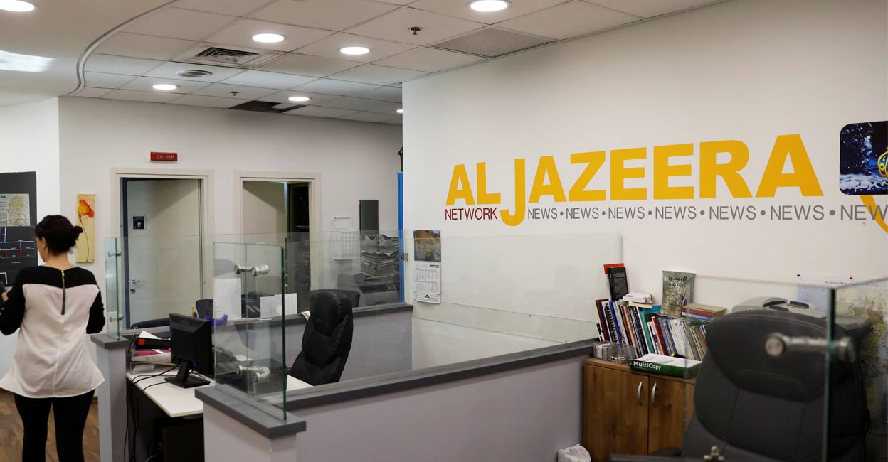 An employee walks inside the Al-Jazeera office in Jerusalem, June 13, 2017. File Photo: Reuters. 