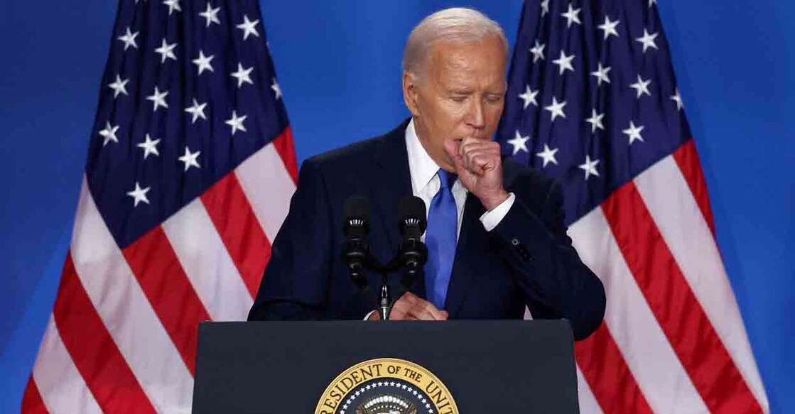 U.S. President Joe Biden coughs at a press conference during NATO's 75th anniversary summit, in Washington, U.S., July 11, 2024. REUTERS/Yves Herman