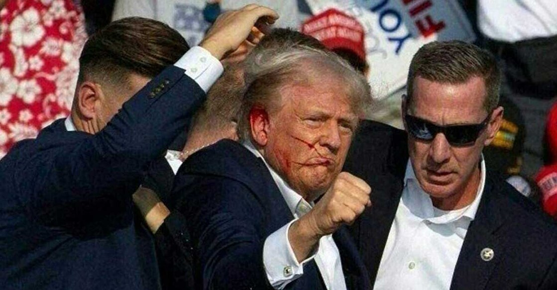 Republican candidate Donald Trump is seen with what appears to be blood on his face surrounded by secret service agents as he is taken off the stage at a campaign event at Butler Farm Show Inc. in Butler, Pennsylvania, July 13, 2024. Republican candidate Donald Trump was evacuated from the stage at today's rally after what sounded like shots rang out at the event in Pennsylvania, according to AFP.
The former US president was seen with blood on his right ear as he was surrounded by security agents, who hustled him off the stage as he pumped his first to the crowd.
Trump was bundled into an SUV and driven away. (Photo by Rebecca DROKE / AFP)