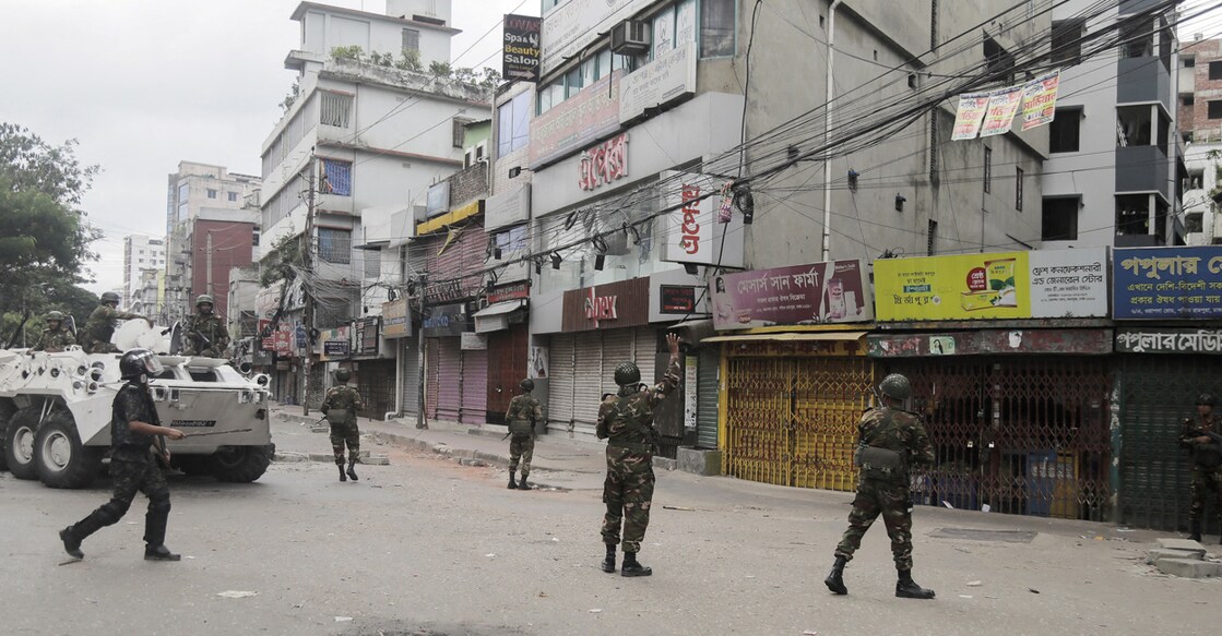 Members of the Bangladesh Army instruct onlookers to stay indoors at the Rampura area, during a curfew imposed in response to the protests. Photo: Reuters/Anik Rahman