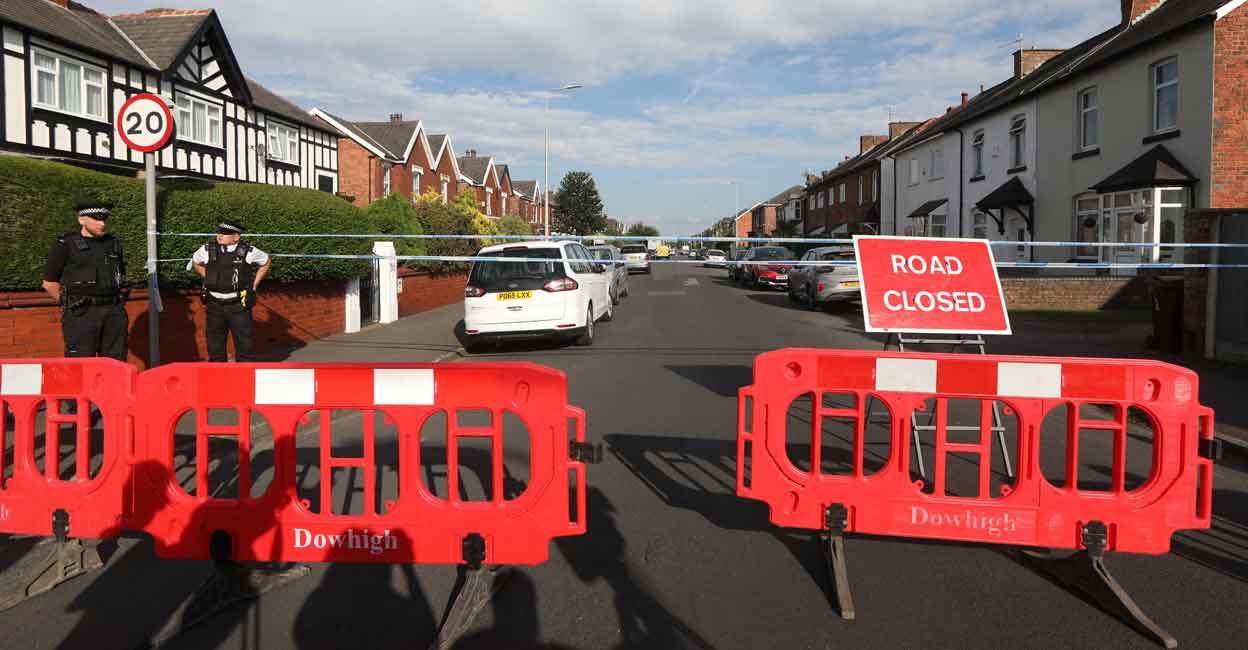 Police officers stand guard at a closed road near the scene where a man was arrested after people were stabbed in Southport, Britain, July 29, 2024. Photo: Reuters/Temilade Adelaja