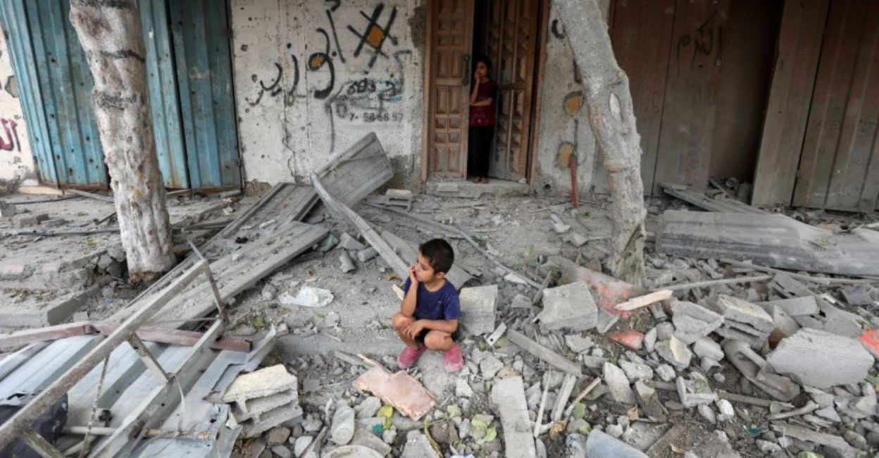 A Palestinian boy sits at the site of an Israeli strike on a house, amid the Israel-Hamas conflict, in Maghazi refugee camp in the central Gaza Strip, August 14, 2024. File Photo: Reuters/Ramadan Abed