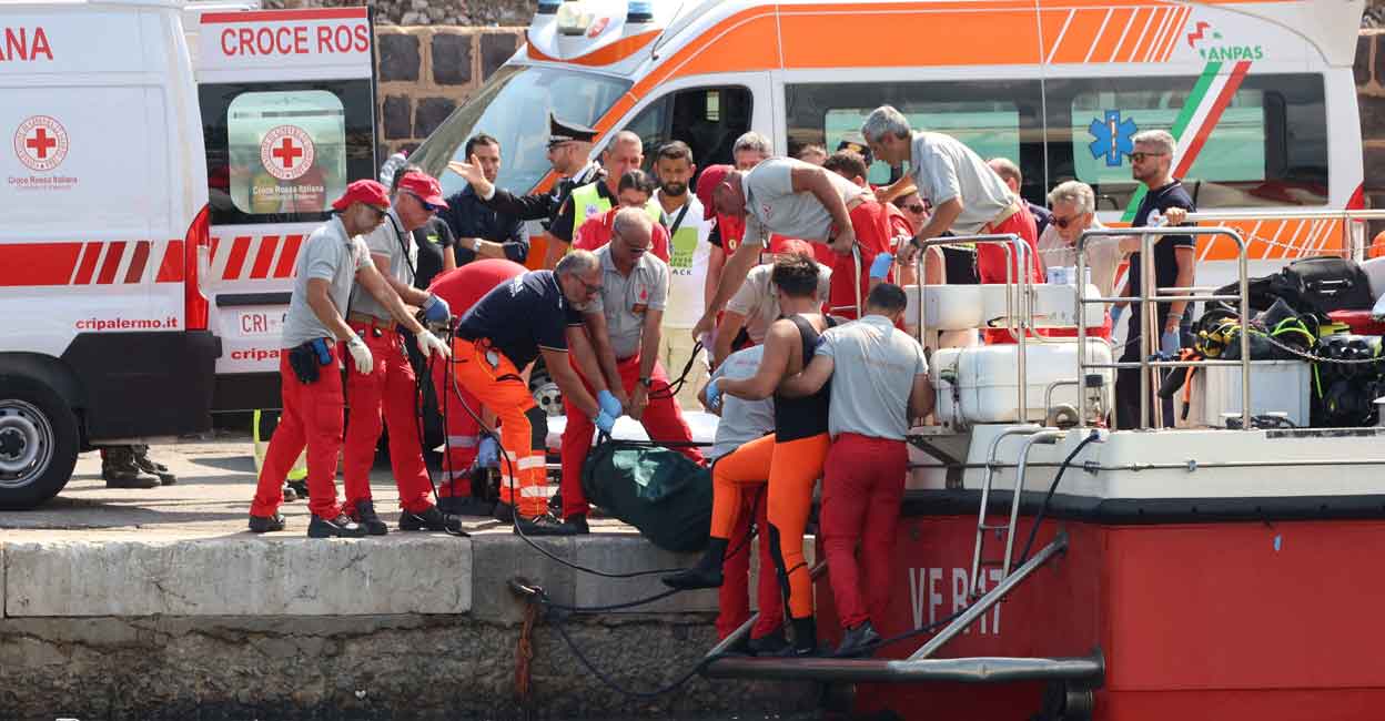 ITALY-SHIP Emergency services carry a body bag after a sailboat sank in the early hours of Monday, off the coast of Porticello, near the Sicilian city of Palermo. Photo: Reuters/Igor Petyx