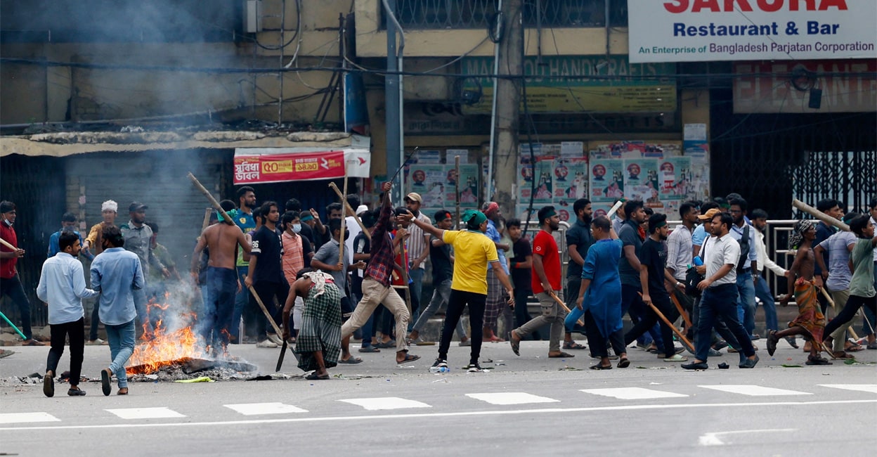 bangladesh Objects set on fire burn as demonstartors with sticks occupy the street during a protest demanding the stepping down of Bangladesh PM. Image: REUTERS/Mohammad Ponir Hossain