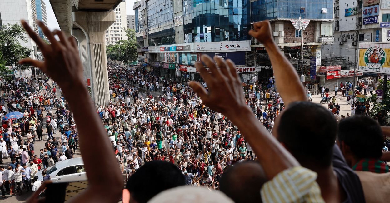 bangladesh-chaos-1.jpg People wave hands as they celebrate the resignation of Prime Minister Sheikh Hasina in Dhaka, Bangladesh, August 5, 2024. Photo: Reuters/Mohammad Ponir Hossain