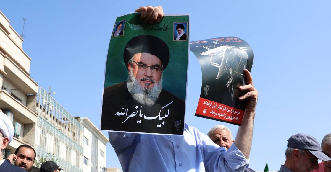 An Iranian man raises a picture of Lebanon's Hezbollah chief Hassan Nasrallah during an anti-Israel protest in Tehran. Photo: AFP