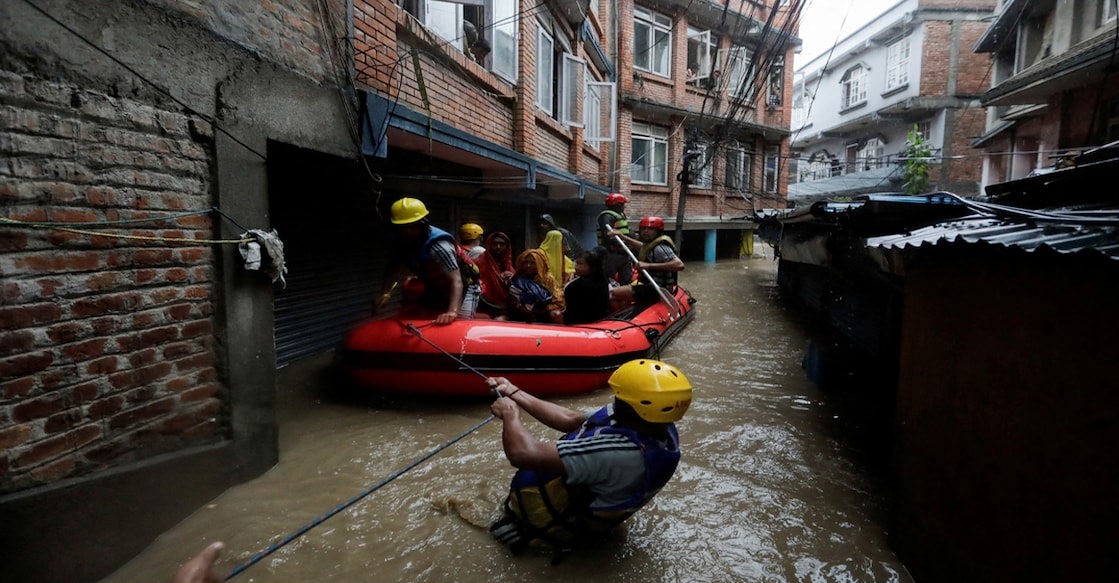 Security force members use an inflatable raft to bring residents to safety from a flooded area near the bank of the overflowing Bagmati River following heavy rains, in Kathmandu, Nepal September 28, 2024. REUTERS/Navesh Chitrakar