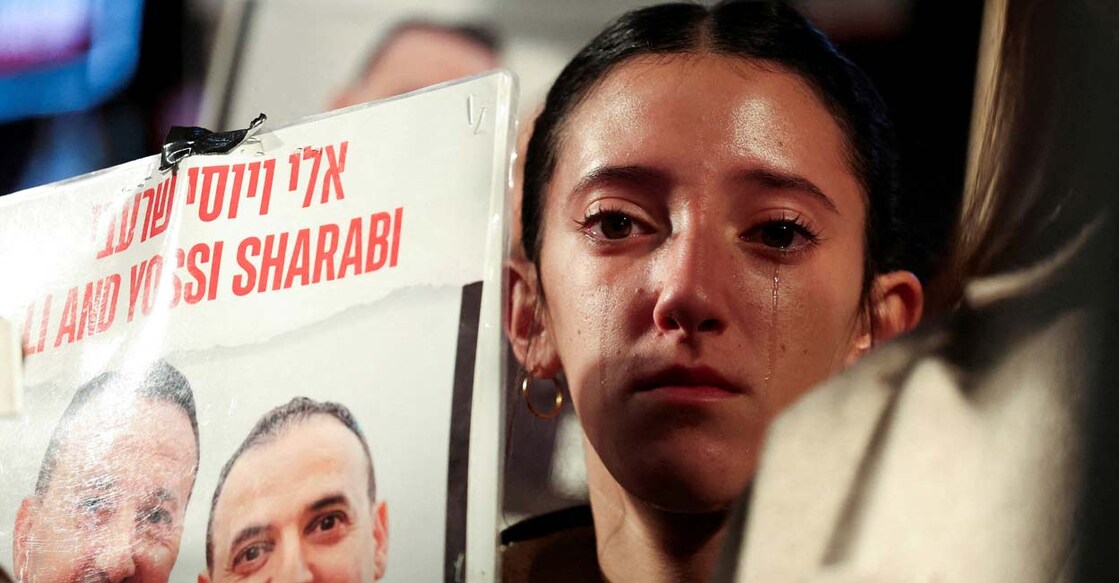 Ofir Sharabi, daughter of the late Yossi Sharabi and niece of Eli Sharabi, reacts as people gather in support of the Israeli hostages. Photo: REUTERS/Nir Elias