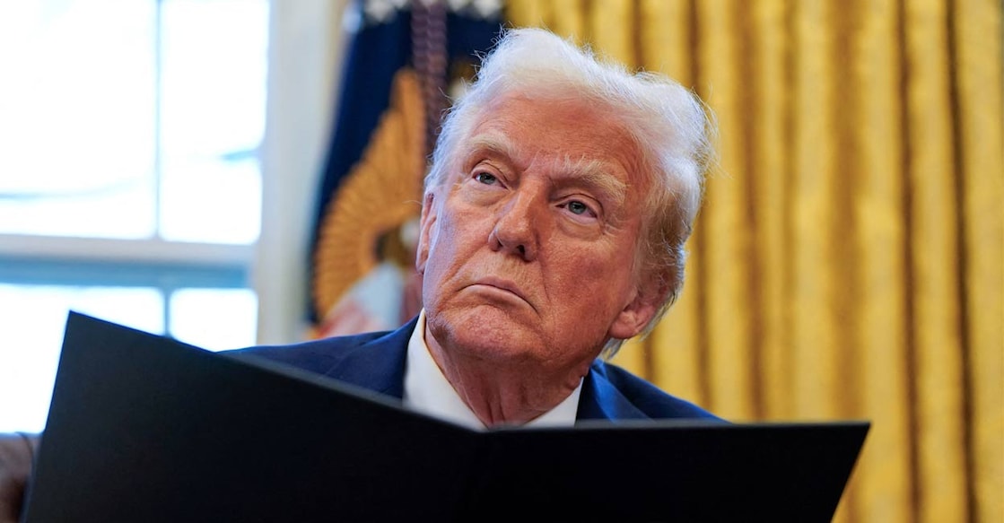 US President Donald Trump signs executive orders in the Oval Office at the White House in Washington, US, January 30, 2025. Photo: Reuters. 