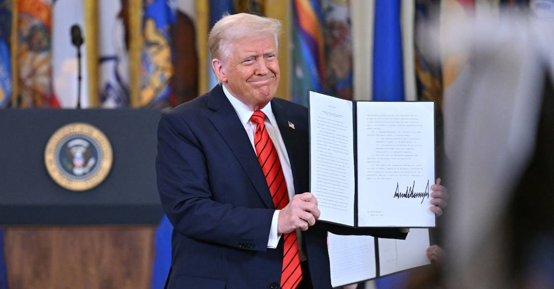 US President Donald Trump shows the executive order aimed at dismantling the Education Department after signing it at the White House in Washington, DC. Photo: AFP