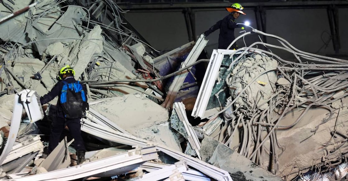 Rescue personnel search for casualties at the site of a building that collapsed after a strong earthquake struck central Myanmar on Friday. Photo: Reuters