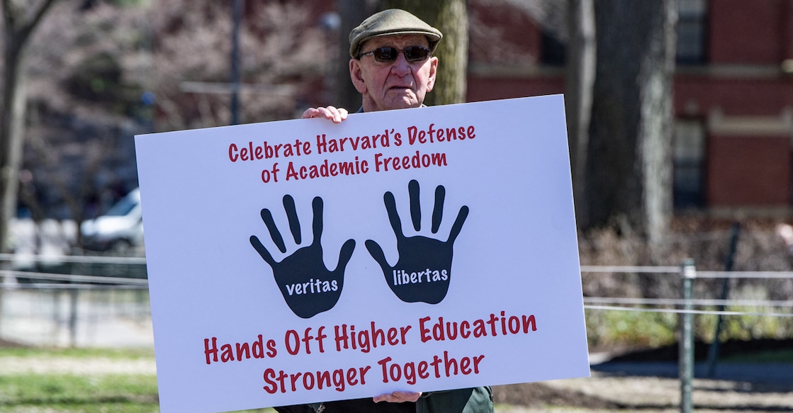 A Harvard Faculty member holds a sign against President Donald Trump’s attacks on Harvard University at Harvard University in Cambridge, Massachusetts on April 17, 2025. Photo: Joseph Prezioso / AFP