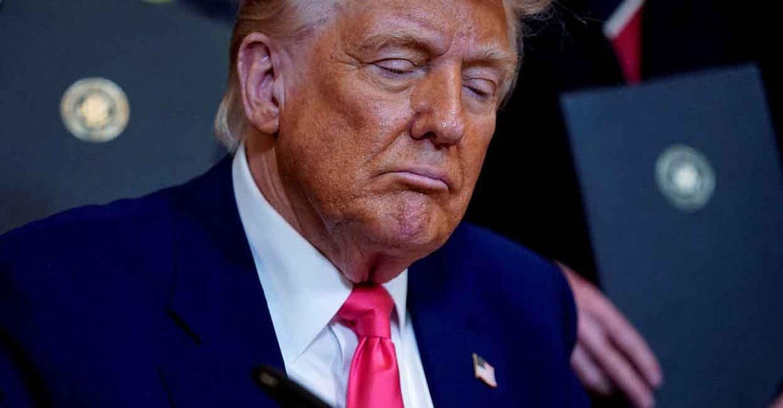 USA-TRUMP-FUNDING-UNIVERSITIES FILE PHOTO: U.S. President Donald Trump signs an executive order at the White House in Washington, D.C., U.S., April 8, 2025. REUTERS/Nathan Howard/File Photo