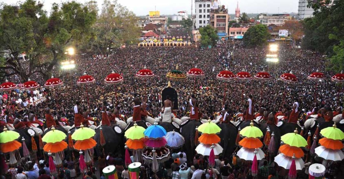 Thousands of Pooram fans watch the processions led by caparisoned elephants in Thrissur, in the southern Kerala state on May 1, 2012. The Thrissur pooram, known as mother of all temple fesitvals, was introduced over a century back by the rulers of erstwhile Kochi princely state.  Since then, the festival is celebrated every year by people in the  locality setting aside even religious divides.  AFP PHOTO/ STR (Photo by STRDEL / AFP)