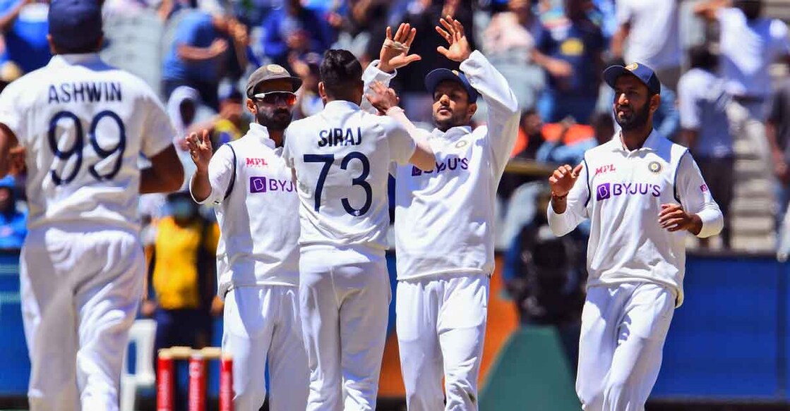 Indian players celebrate the fall of an Australian wicket. Photo: AFP