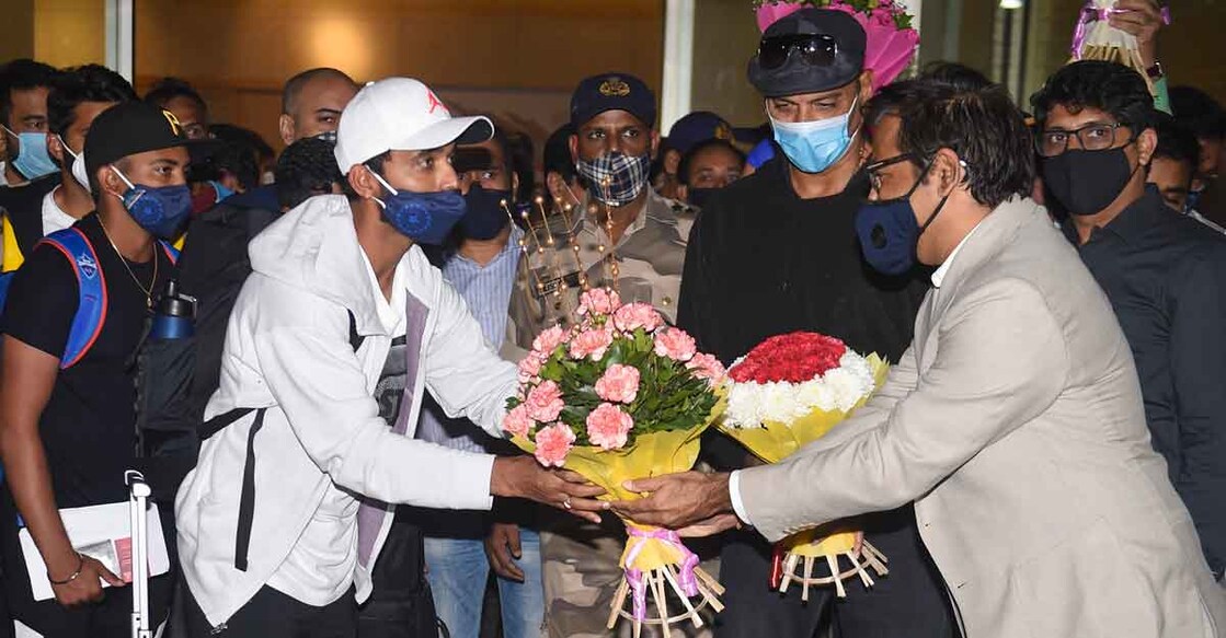 Ajinkya Rahane being presented with a bouquet on arrival at the Mumbai airport. Photo: PTI