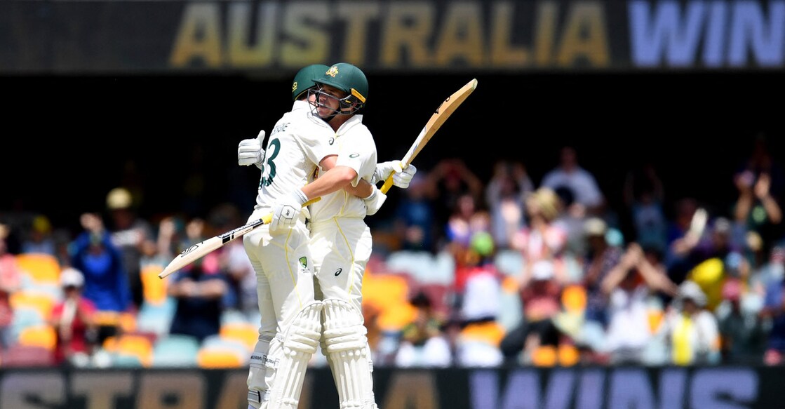 Australia's Marnus Labuschagne, left, and Marcus Harris celebrate after Australia won the first Test. Photo: AFP/ Dan Peled