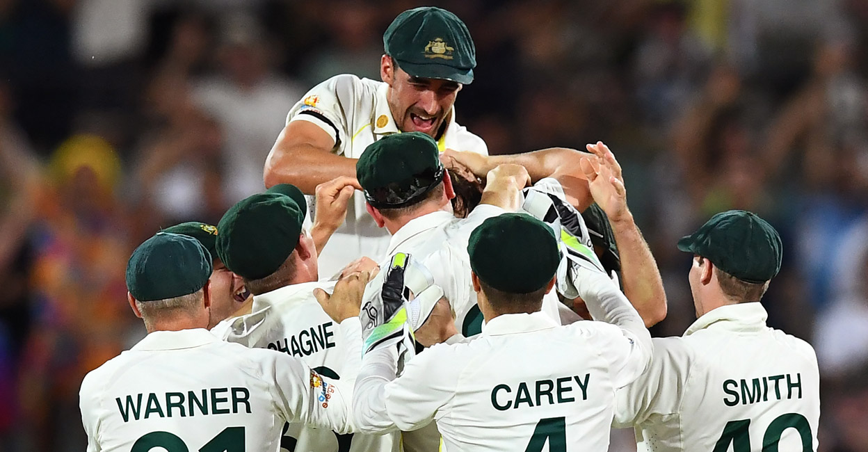 Australian players congratulate debutant Michael Neser on claiming his maiden Test wicket. Photo: AFP/ William West