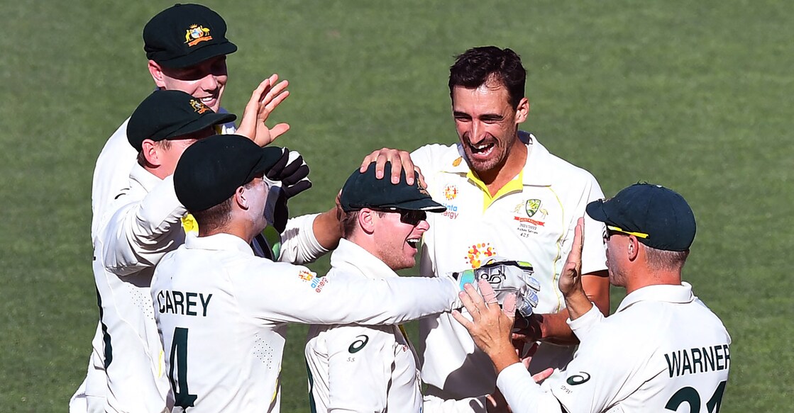 Australia's Mitchell Starc, second right, and Steve Smith, centre, celebrate with teammates after combining to dismiss Dawid Malan. Photo: AFP/William West