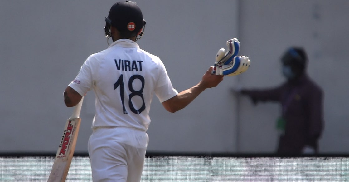 Virat Kohli gestures as he walks back to the dressing room. Photo: AFP/Punit Paranjpe