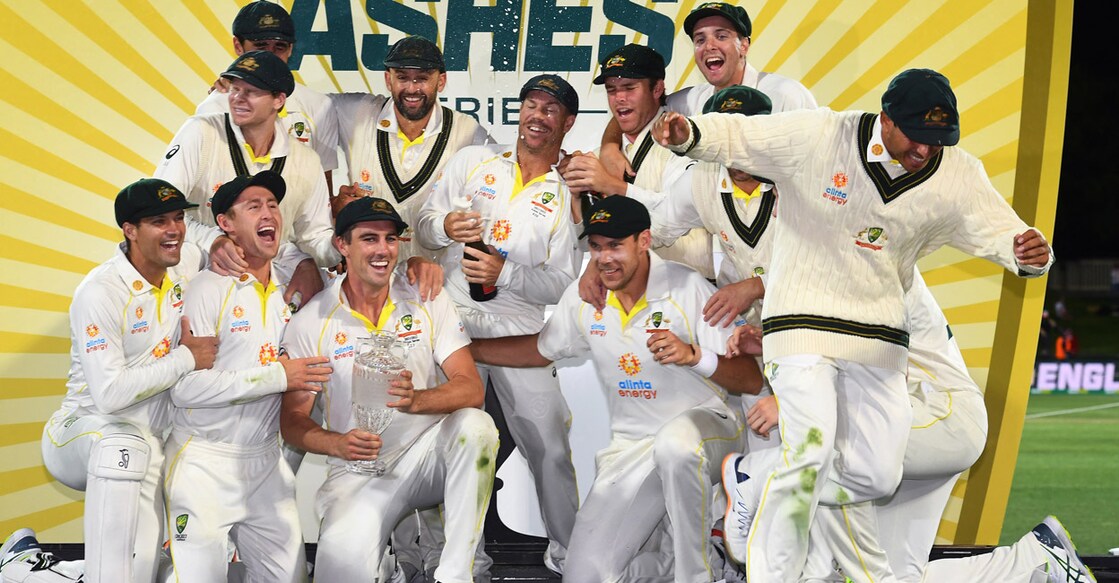 Australian players celebrate with the trophy. Photo: AFP/William West
