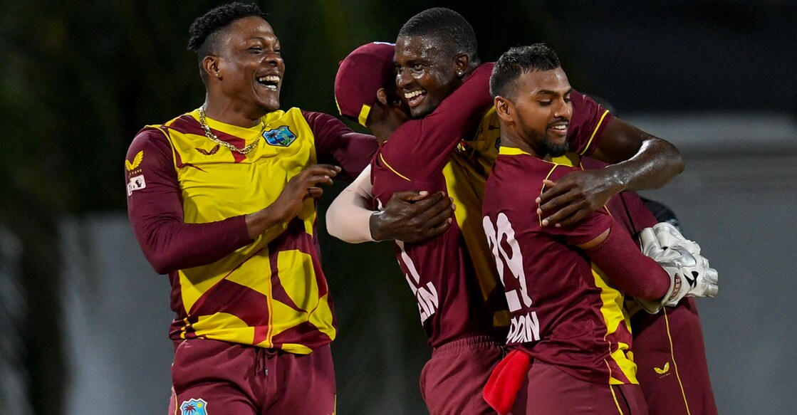 Jason Holder, right, celebrates with teammates after winning the match. Photo: AFP/
Randy Brooks