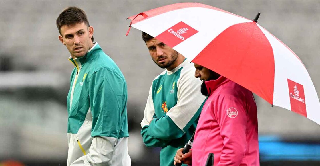 Australian players Mitchell Marsh and Marcus Stoinis chat with umpire Aleem Dar. Photo: AFP/William West