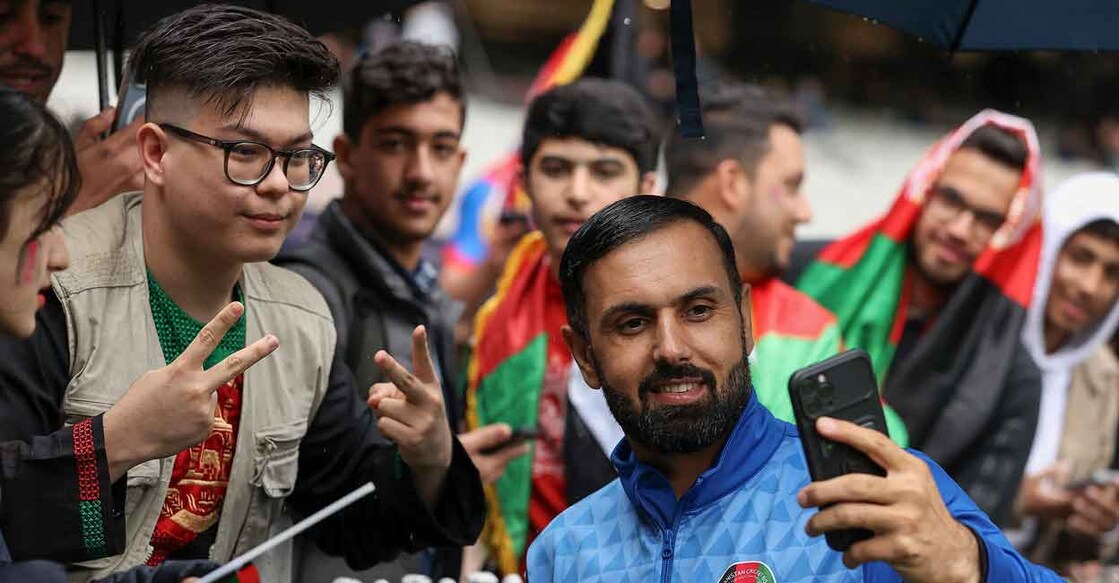 Afghhan captain Mohammad Nabi poses for a selfie with the fans at the MCG. Photo: AFP/Martin Keep