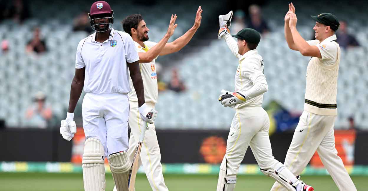 Jason Holder walks off after being dismissed by Mitchell Starc. Photo: AFP/William West