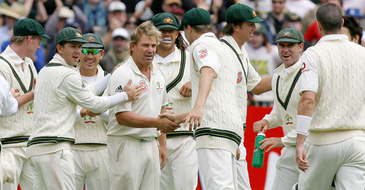 Shane Warne is congratulated by his teammates on picking up his 700th Test wicket in the 2006-07 Ashes. File photo: AFP/William West
