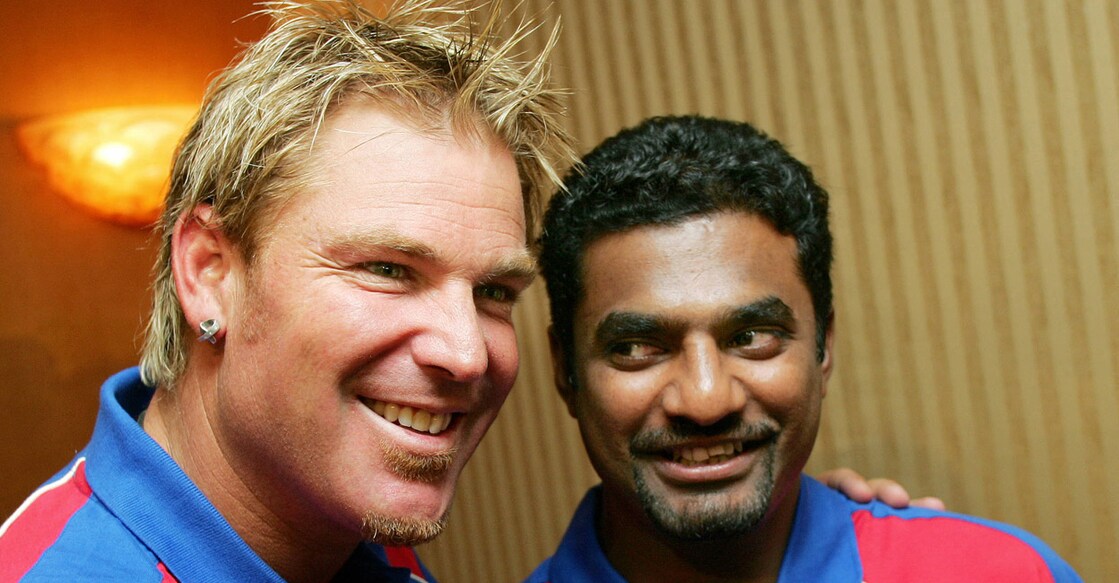 Shane Warne with Muttiah Muralitharan. File photo: AFP/William West