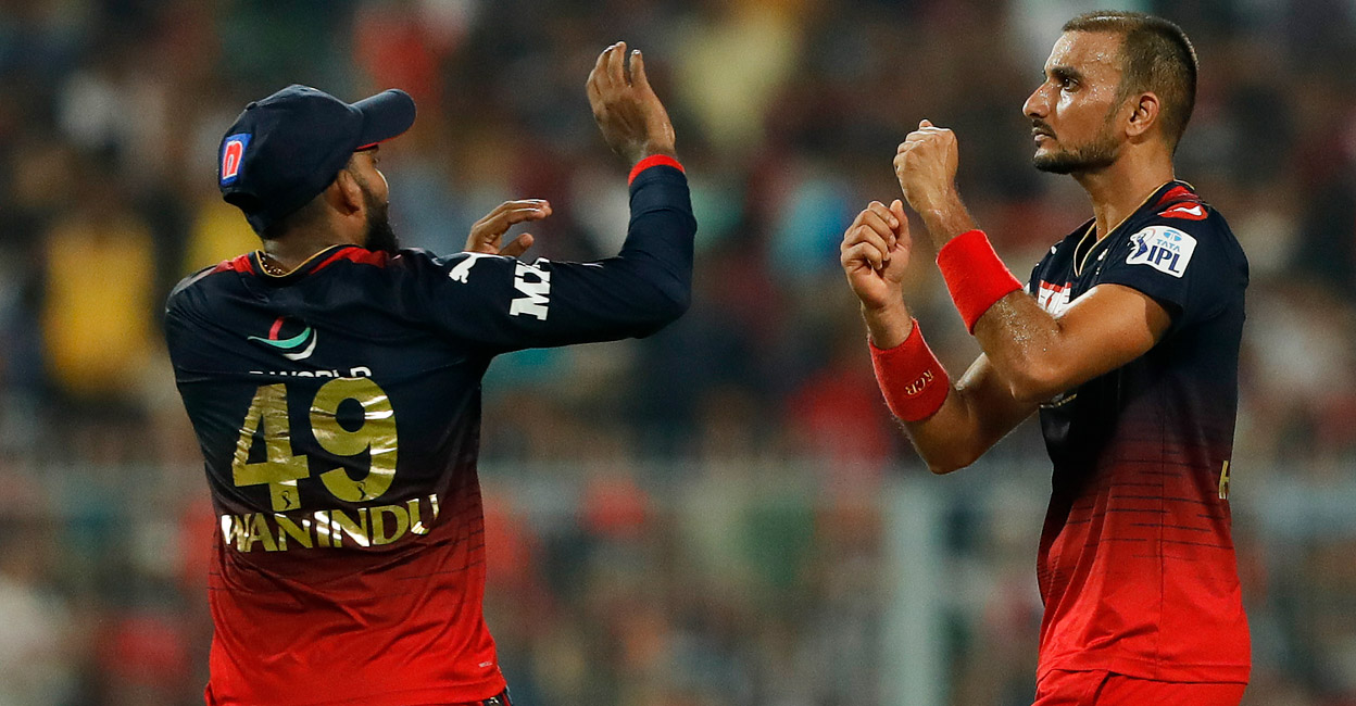Harshal Patel, right, celebrates with Wanindu Hasaranga after picking up a wicket. Photo: Twitter@IPL