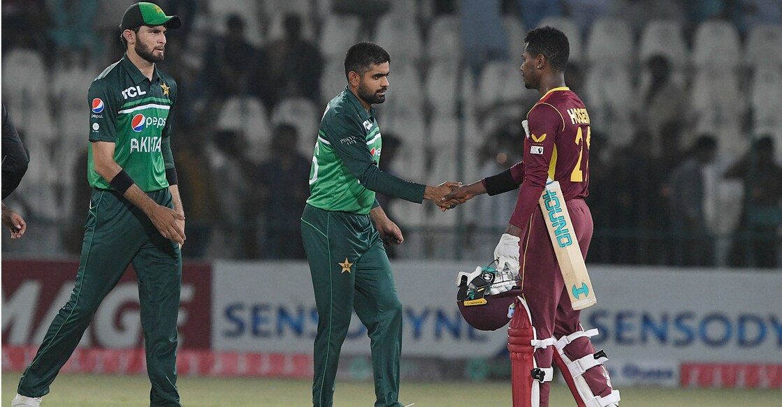 Pakistan captain Babar Azam shakes hands with West Indies' Akeal Hosein after winning the second ODI. Photo: AFP/Aamir Qureshi