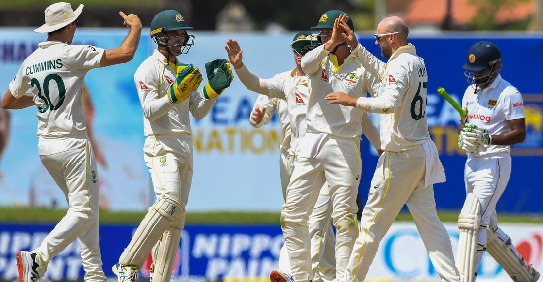 Nathan Lyon. second right, celebrates with teammates after dismissing Sri Lankan captain Dimuth Karunaratne. Photo: AFP/Ishara S Kodikara